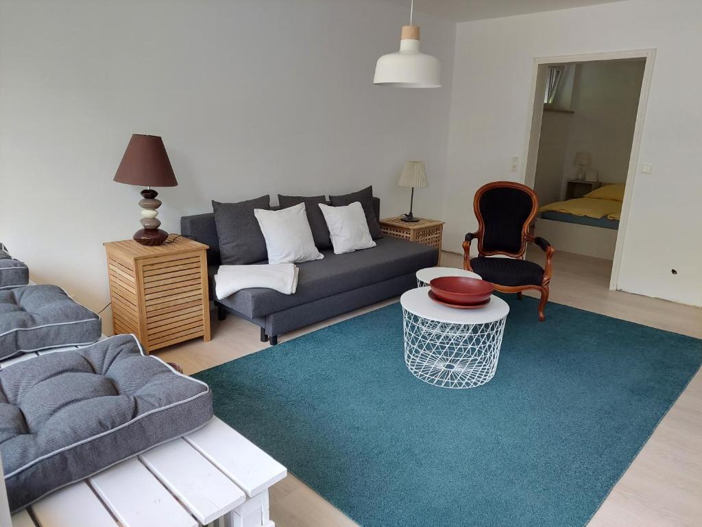 a living room with a couch and a table at Ferienwohnung in Hitzacker in Hitzacker