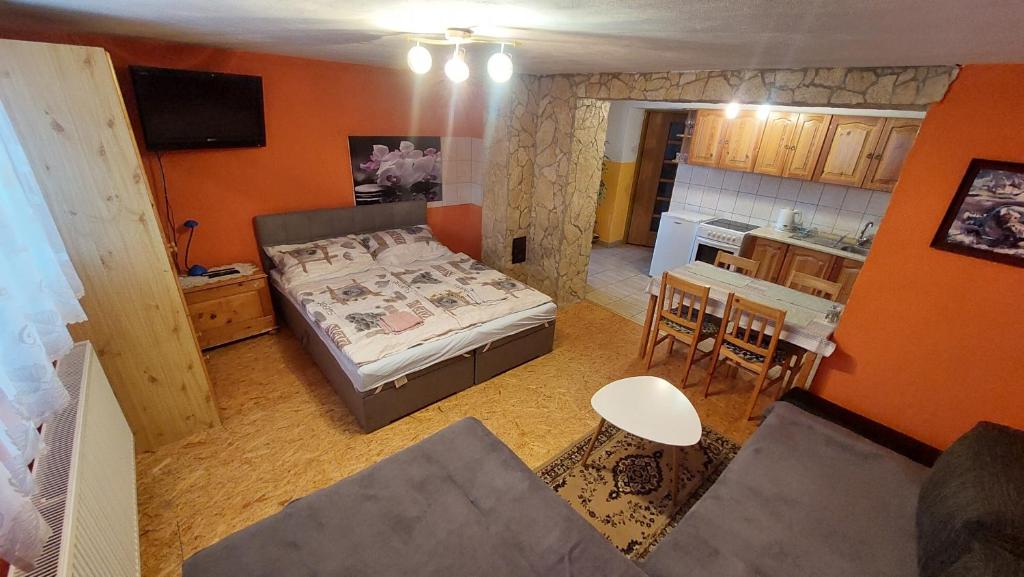 a small room with a bed and a kitchen at Privat 498 in Lúčky