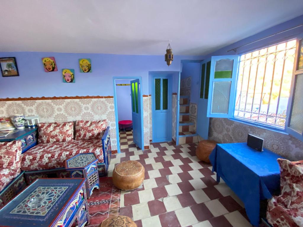 a living room with a couch and a table at Dar Lazrak in Chefchaouen