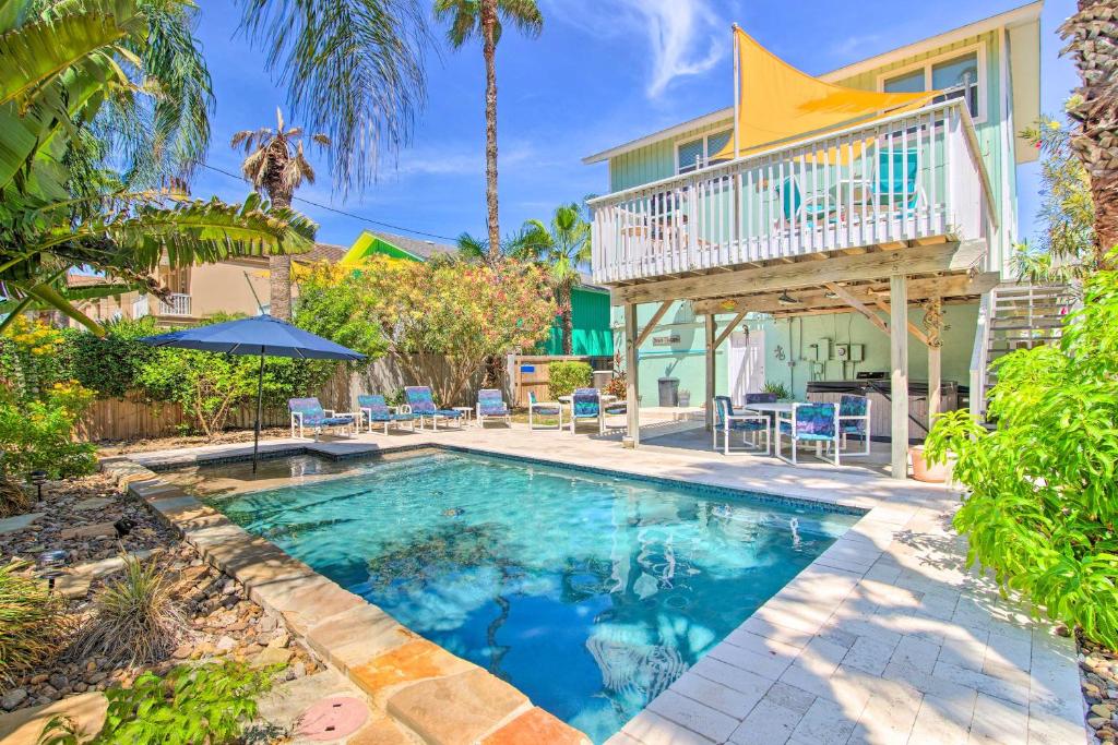una piscina frente a una casa con balcón en Sunny South Padre Home - Steps to the Beach!, en South Padre Island