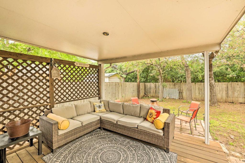 a patio with a couch on a wooden deck at Fort Worth Retreat with Fenced Yard and Fire Pit! in Fort Worth