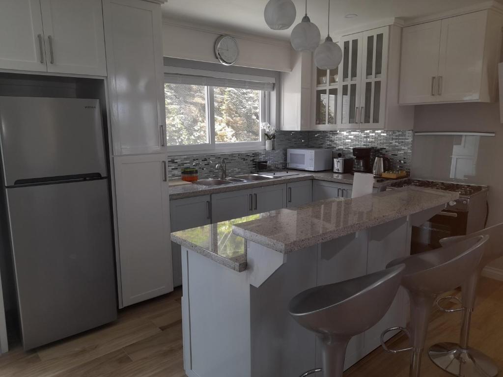 Kuchyň nebo kuchyňský kout v ubytování JemmRose Suites