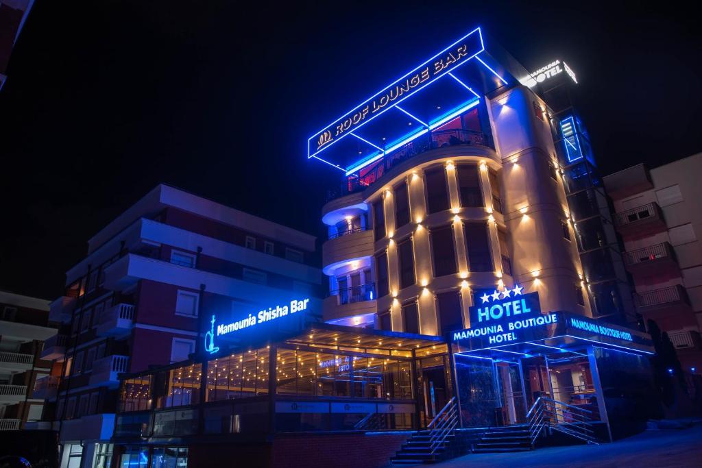 a hotel is lit up in blue and white at Hotel Mamounia Boutique in Prishtinë