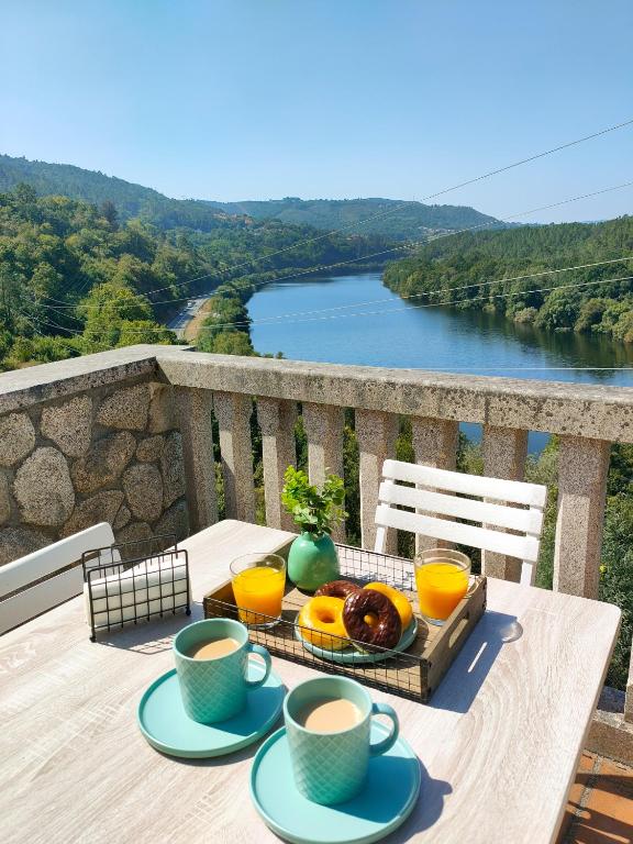a table with a tray of food and two cups of coffee at Lar do Pilís in Ourense