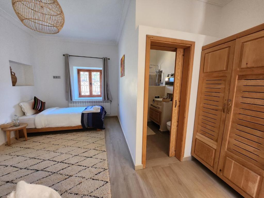 a small bedroom with a bed and a window at AdaZen Ecolodge in Azilal