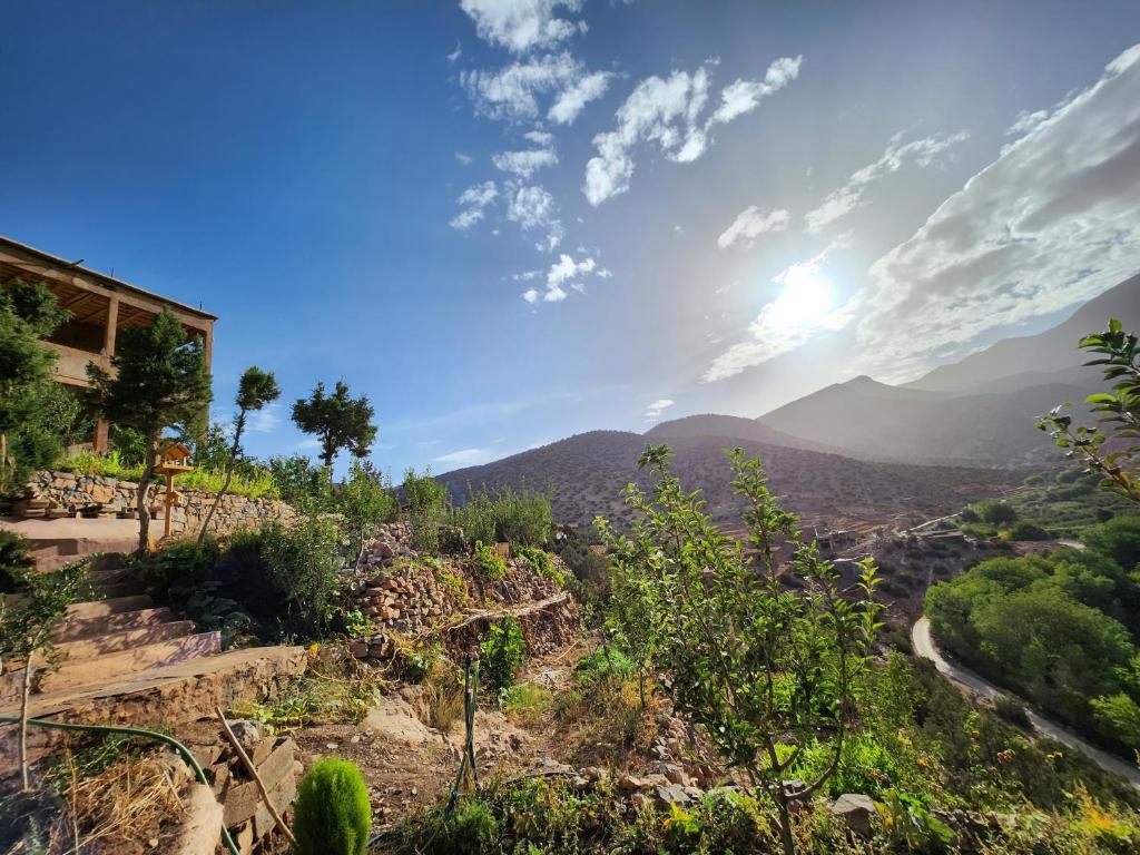 a view of the mountains with the sun in the sky at AdaZen Ecolodge in Azilal
