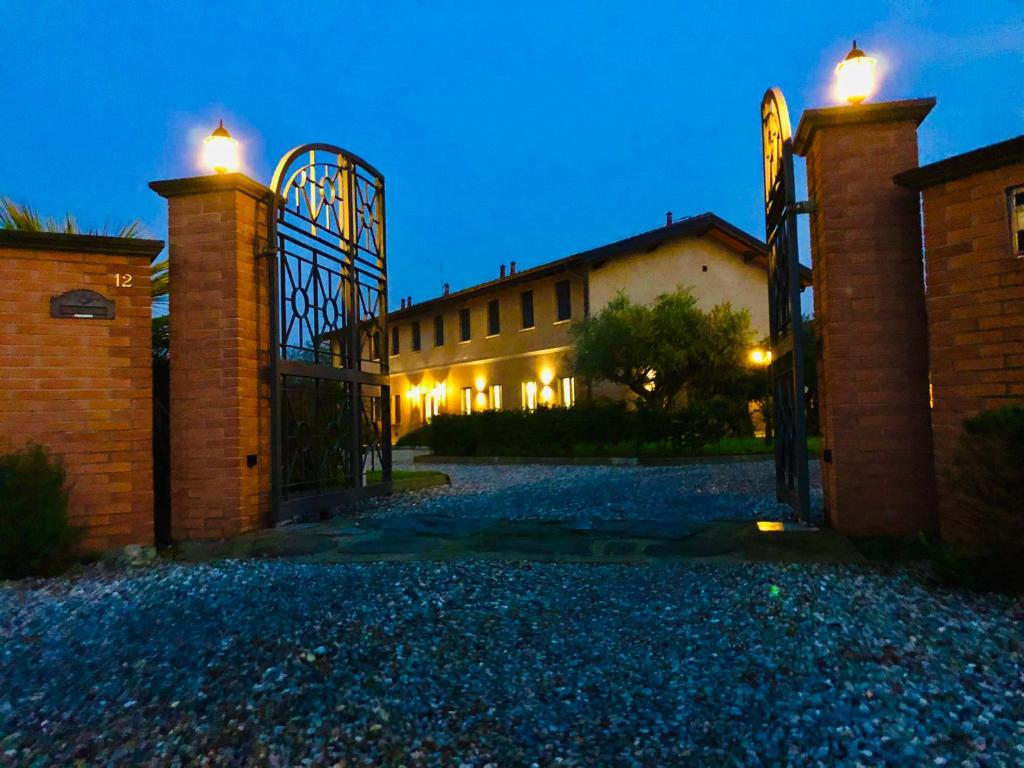 an open gate to a building at night at Locanda in Gessate