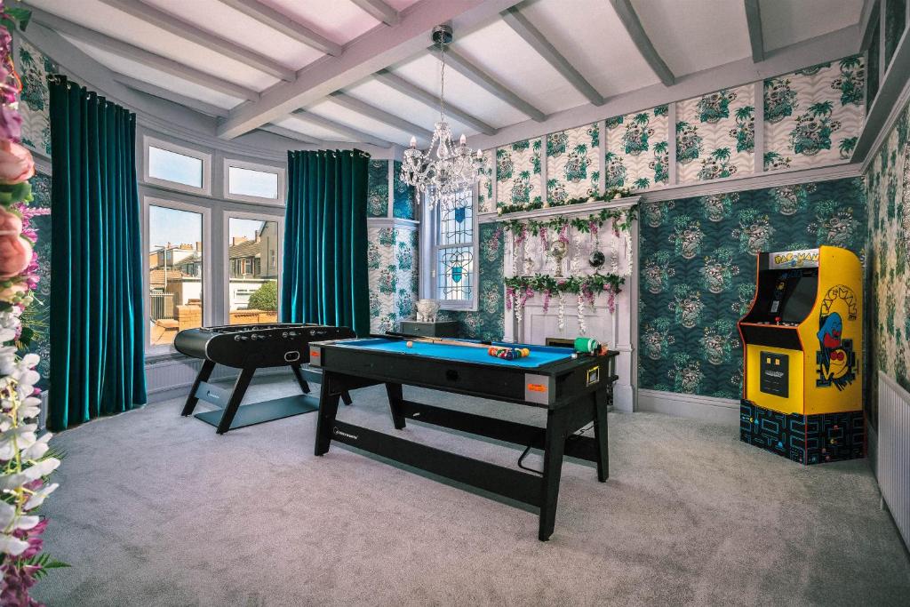 a living room with a pool table and a video game at Empress Hall Blackpool by Charles Alexander Short Stay - Sleeps 20 in Blackpool