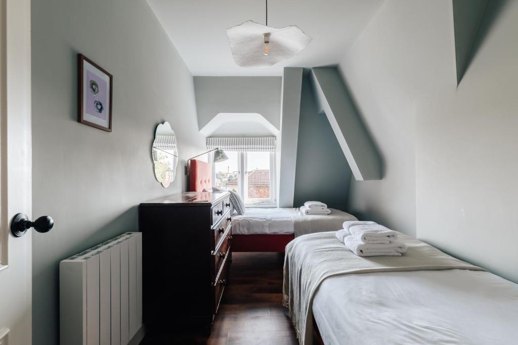 a room with two beds and a mirror at Redland Suites - Apartment 7 in Bristol