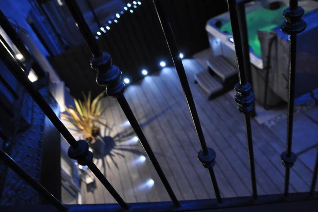 a view of a patio at night with lights at Hot Tub Apartment at Pirn Road in Innerleithen