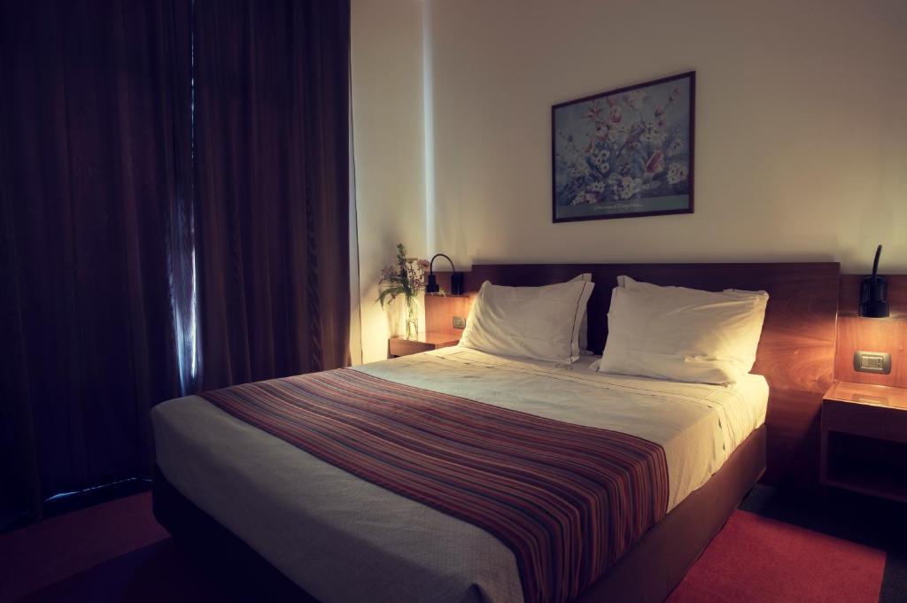 Postel nebo postele na pokoji v ubytování Cangrande Hotel