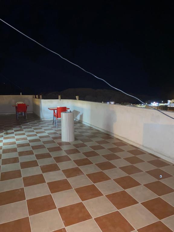 a tiled roof with two chairs and a table on top at Hustle's look in Wadi Musa