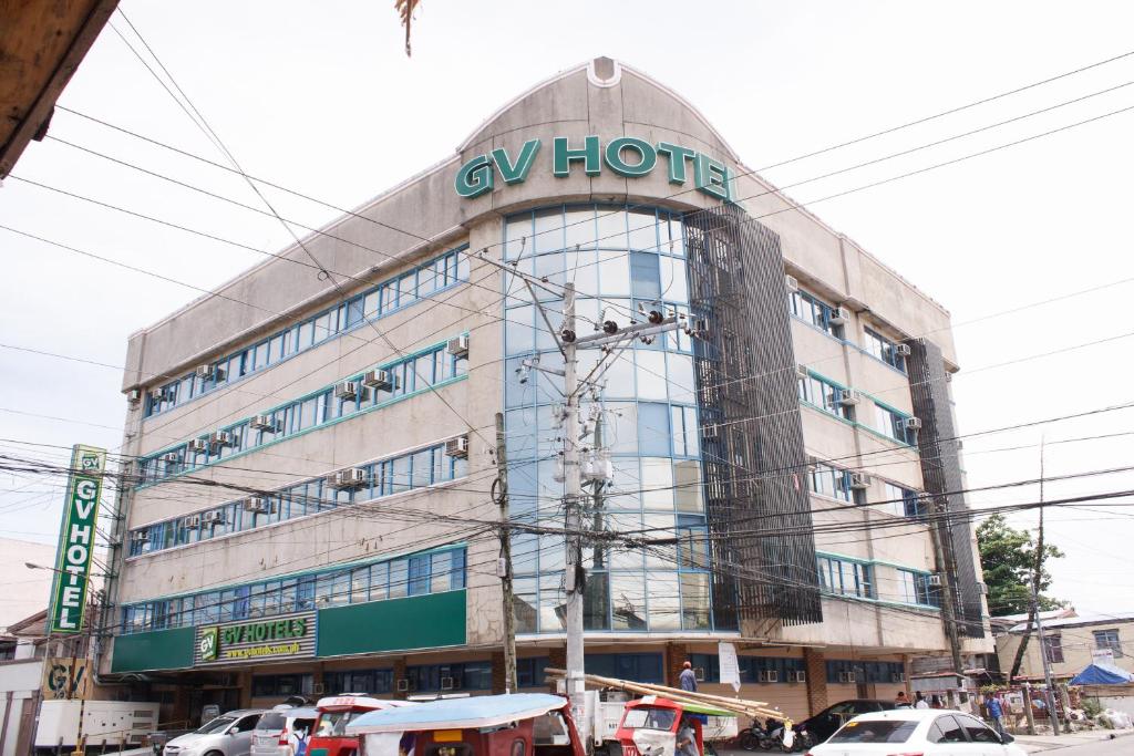 a large building with a sign on top of it at GV Hotel - Tacloban in Tacloban