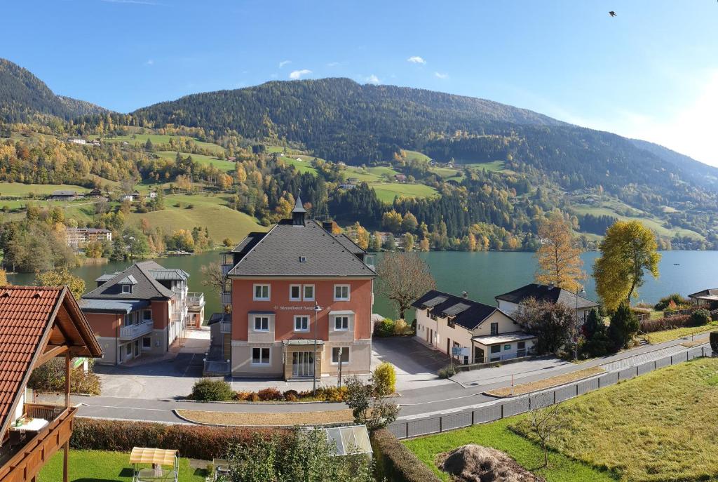 a town with a lake and mountains in the background at Haus Feldseeblick in Feld am See