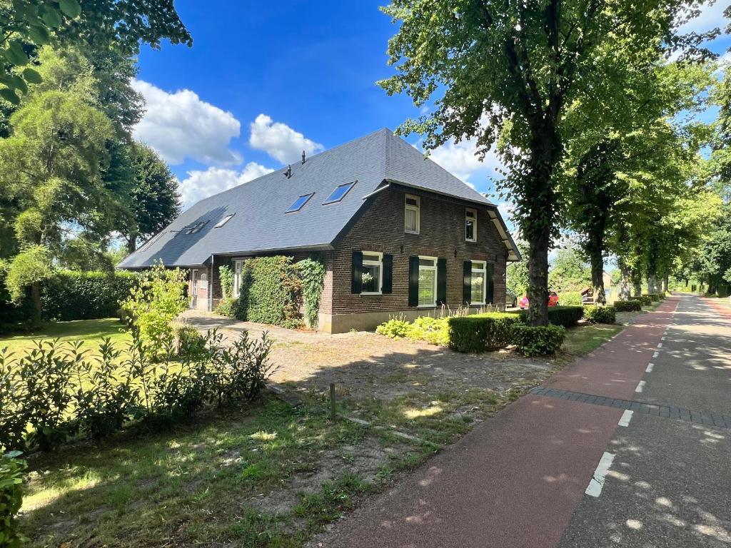 a house with solar panels on the roof at Nisterlo Guesthouse in Nistelrode