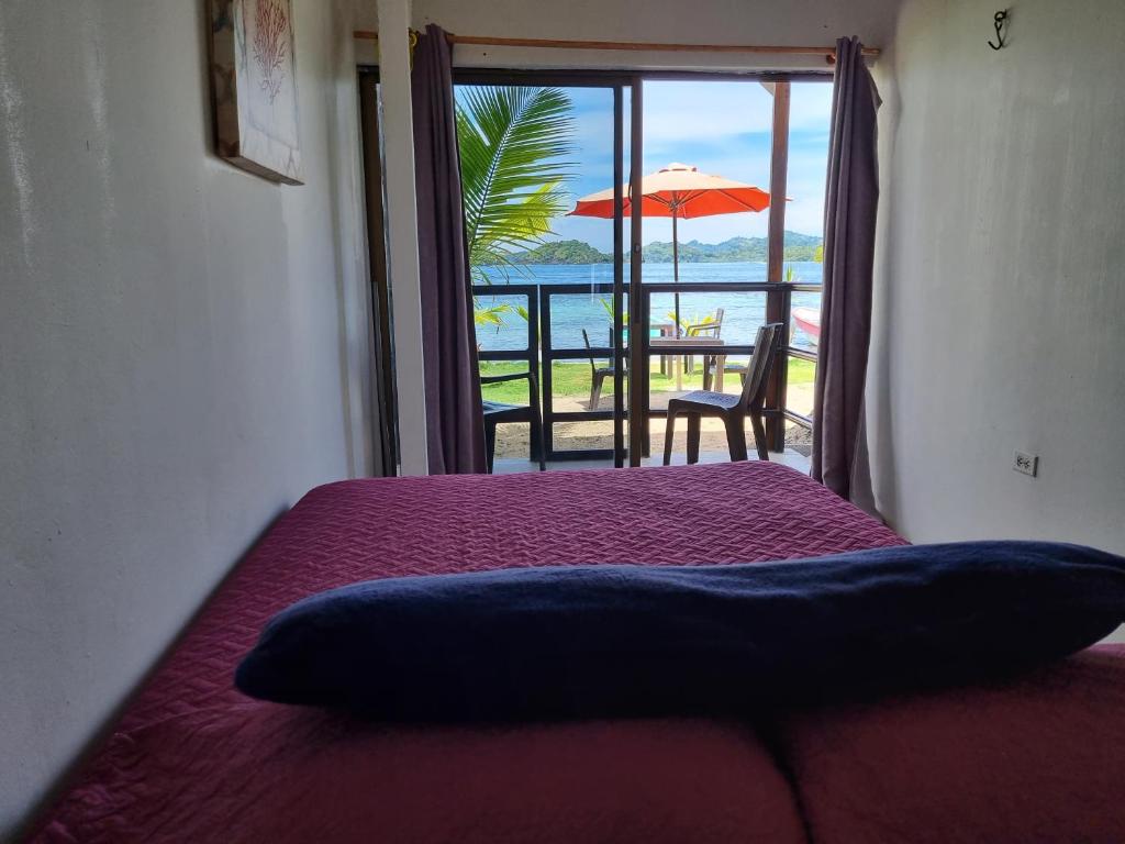 a bedroom with a bed with a view of the ocean at Casa Bajo Congo in Colón