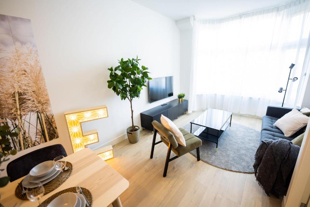 uma sala de estar com um sofá e uma mesa em Earnestly 1 Bedroom Serviced Apartment 54m2 -NB306E- em Roterdã
