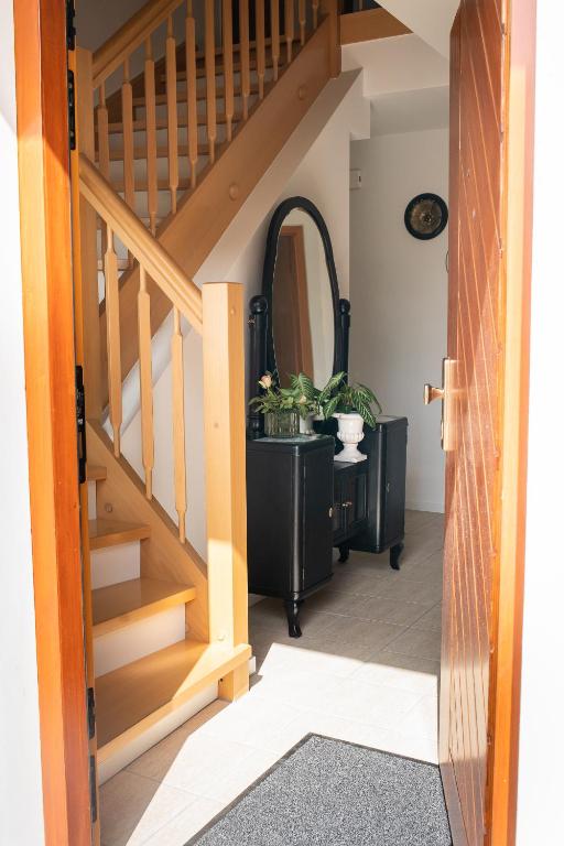 a hallway with stairs and a table with plants at Ferienhaus Kaiserbaum in Illmitz