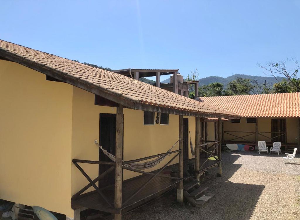 a house with a porch and a roof at Vila do Surfe in Ubatuba