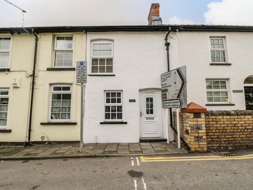 a white house with signs in front of it at The Cwtch in Abergavenny