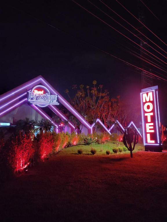 a night view of a disney resort with neon signs at Motel Prestige in Sorocaba