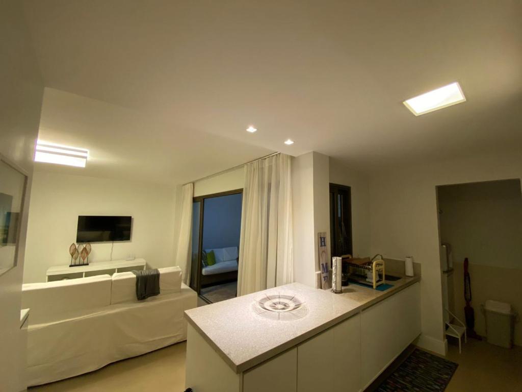 a large living room with a couch and a television at Praia do Forte Iberostar in Praia do Forte