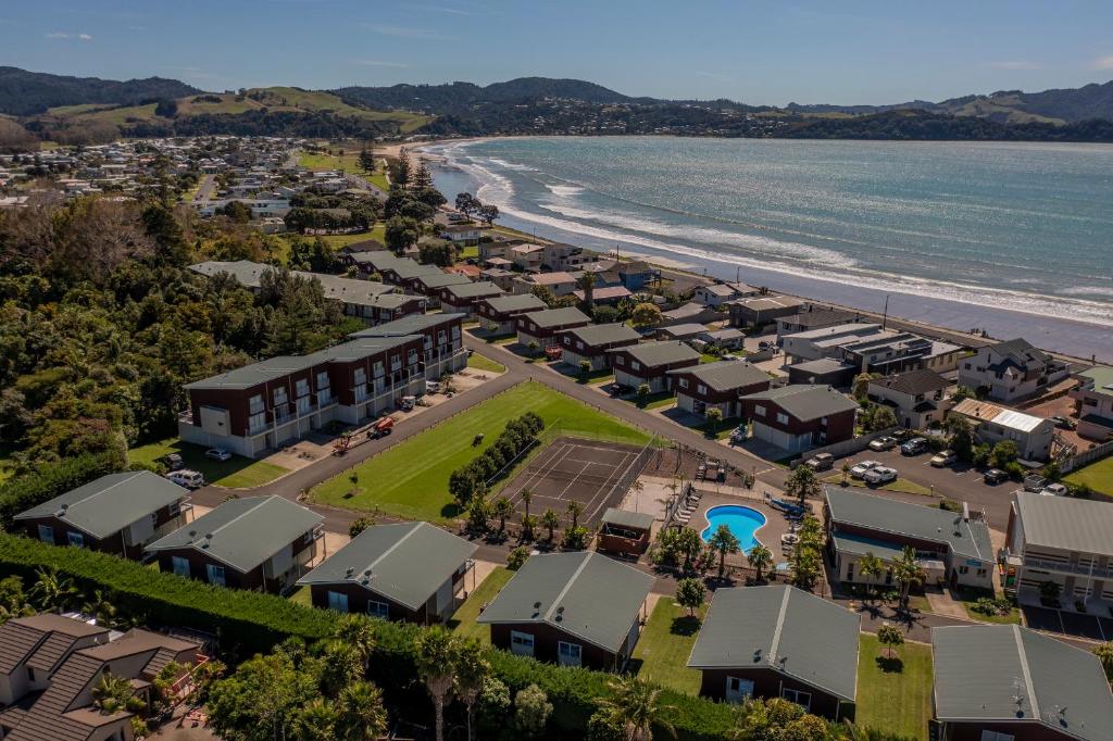 an aerial view of a resort next to the beach at Ocean Serenity Apartments Whitianga in Whitianga