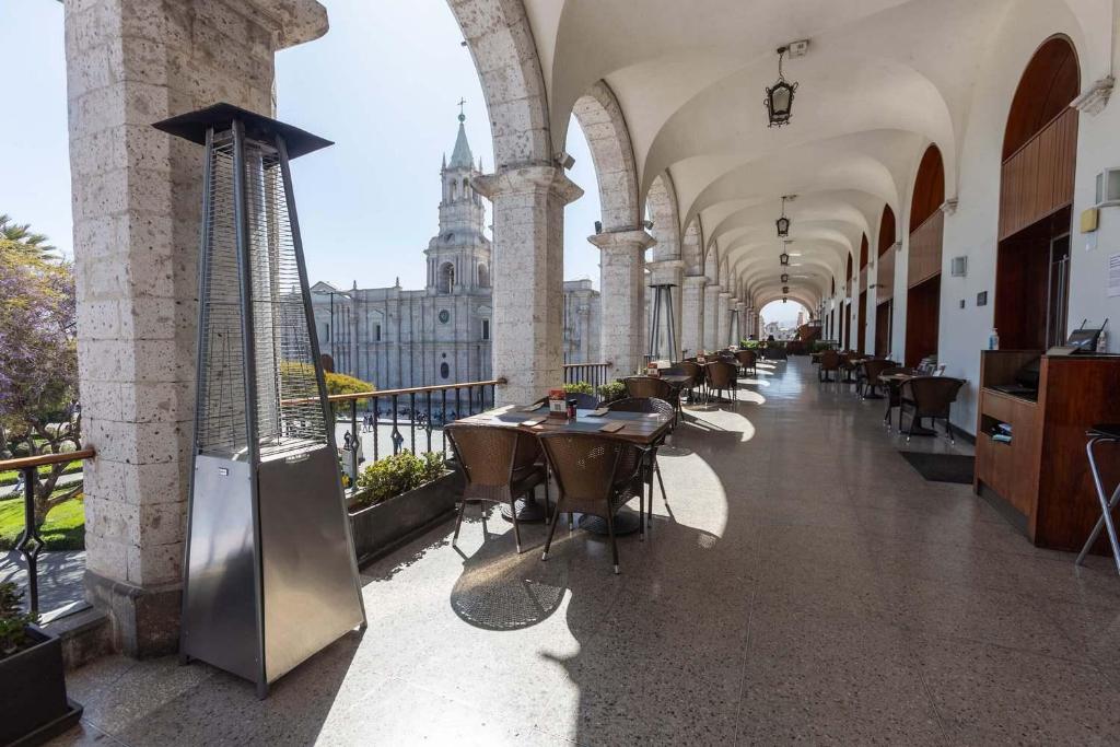 a hallway with tables and chairs in a building at Casa Andina Select Arequipa Plaza in Arequipa