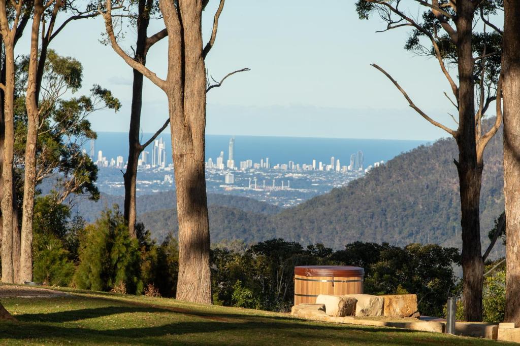 a view of a city from a park with trees at Verandah House Country Estate in Mount Tamborine