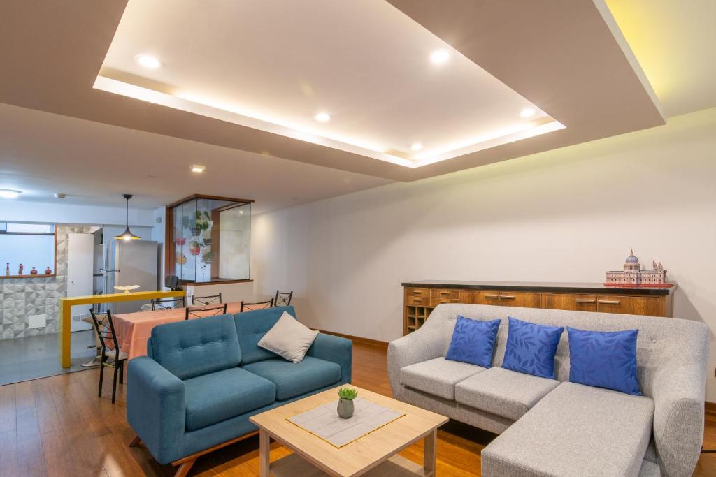 a living room with a couch and a table at Corpac Apartment in Lima