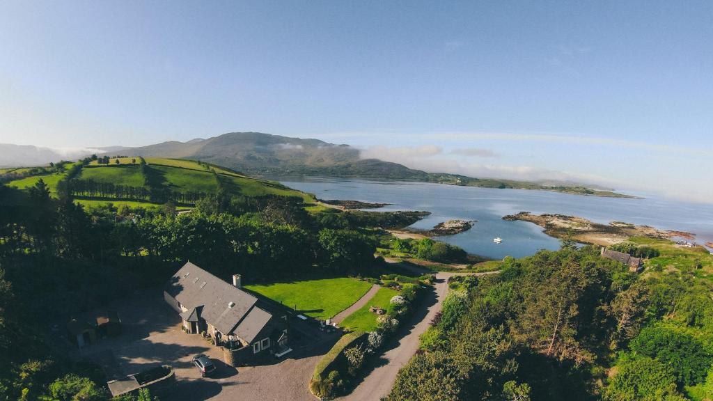 an aerial view of a house on a hill next to a lake at Inḃear Scéine in Kenmare