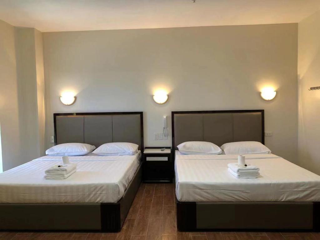Postel nebo postele na pokoji v ubytování Meaco Royal Hotel- Aparri
