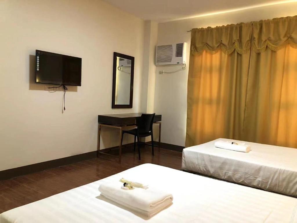 Postel nebo postele na pokoji v ubytování Meaco Royal Hotel- Aparri