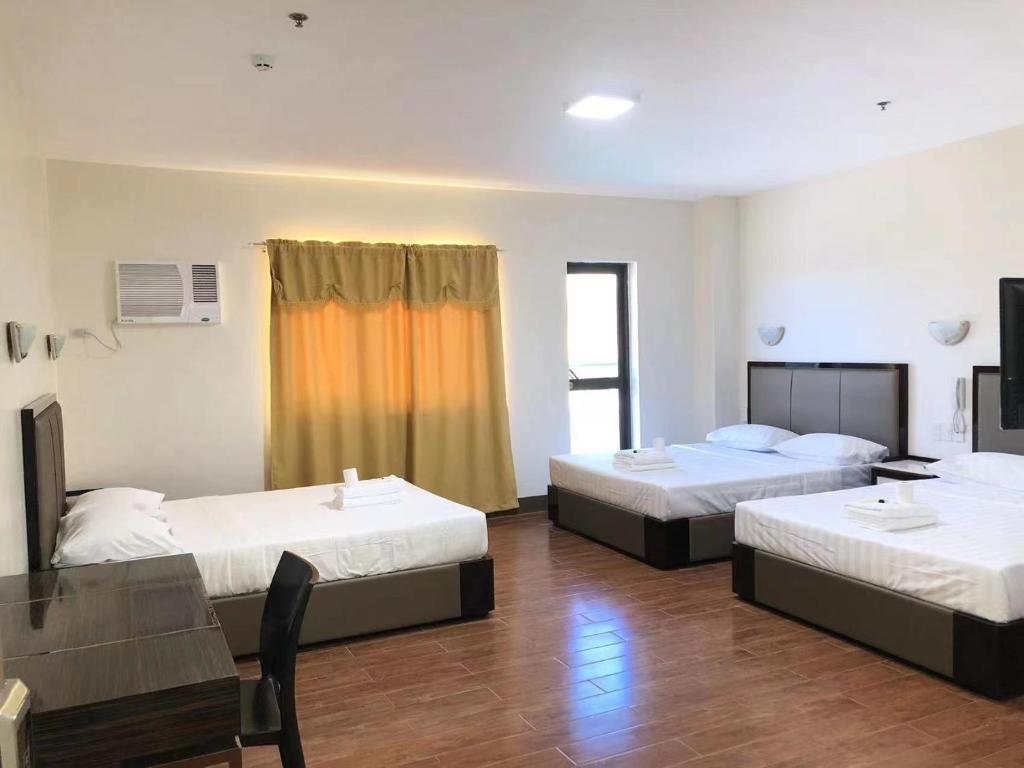 Postel nebo postele na pokoji v ubytování Meaco Royal Hotel- Aparri