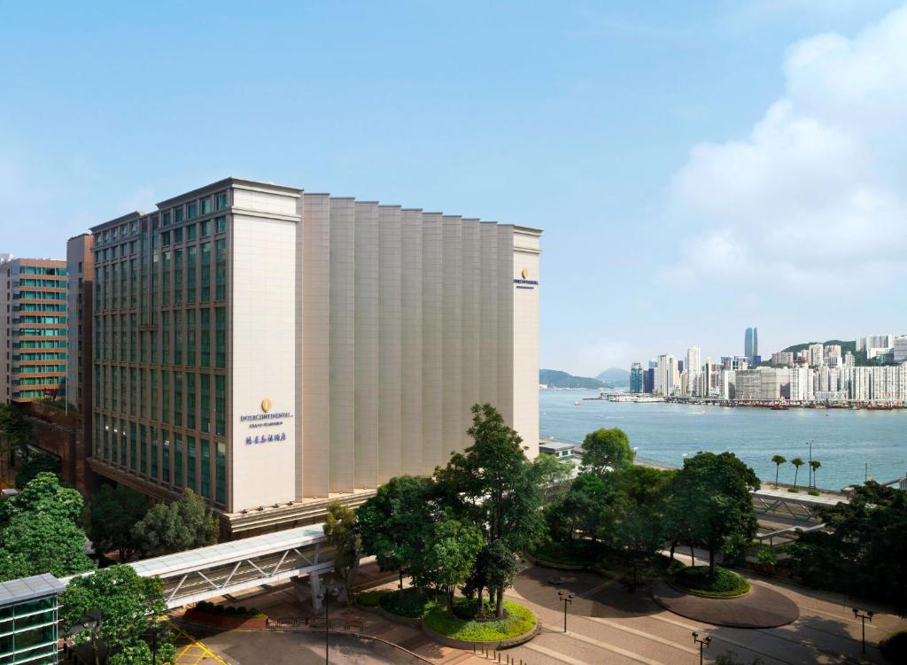 a large building with a view of the ocean at InterContinental Grand Stanford Hong Kong, an IHG Hotel in Hong Kong