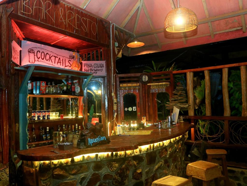 a bar with a wooden counter in a restaurant at Aussie Inn Bukit Lawang in Bukit Lawang