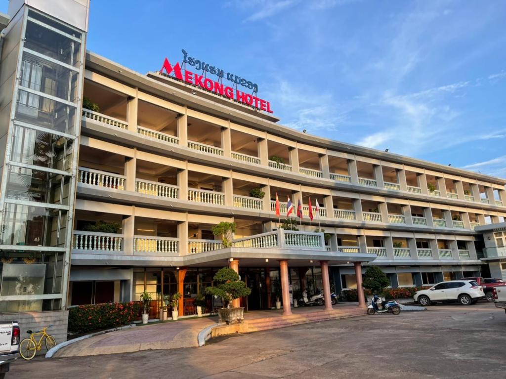 a large building with a sign on top of it at Mekong Hotel in Ban Nabông
