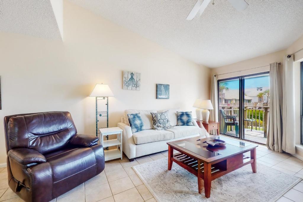 a living room with a couch and a chair and a table at Ocean Mile K-3 in St. George Island