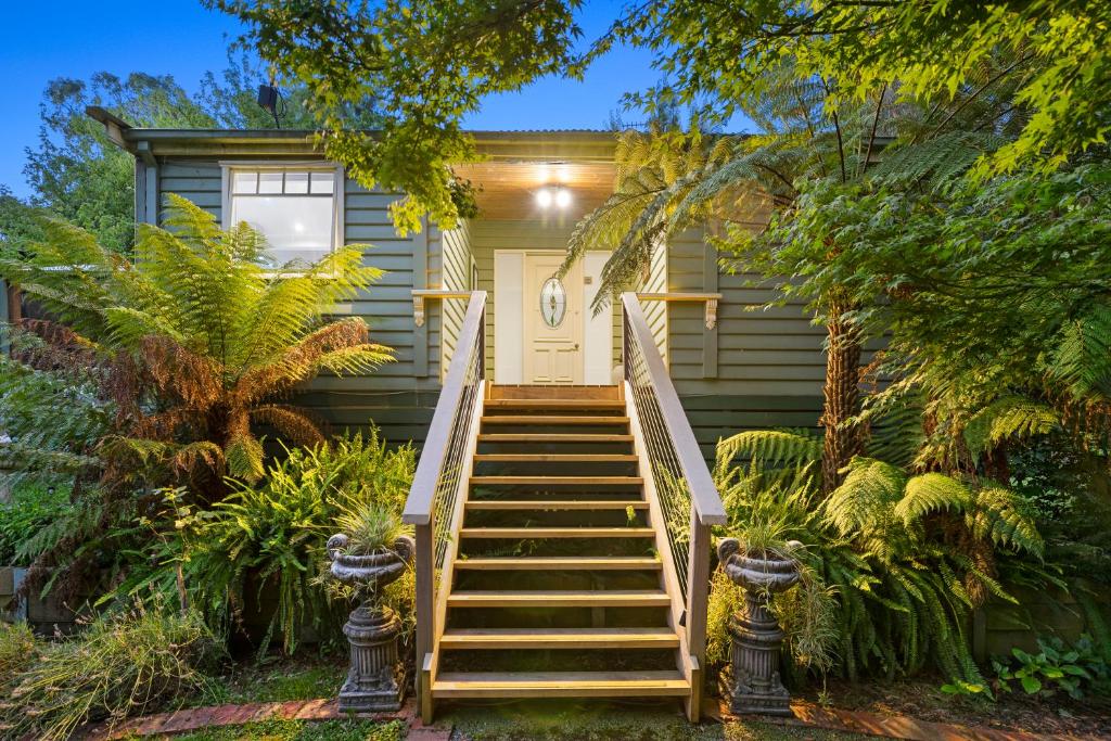 a house with stairs leading to the front door at Paddys Creek Retreat in Upwey