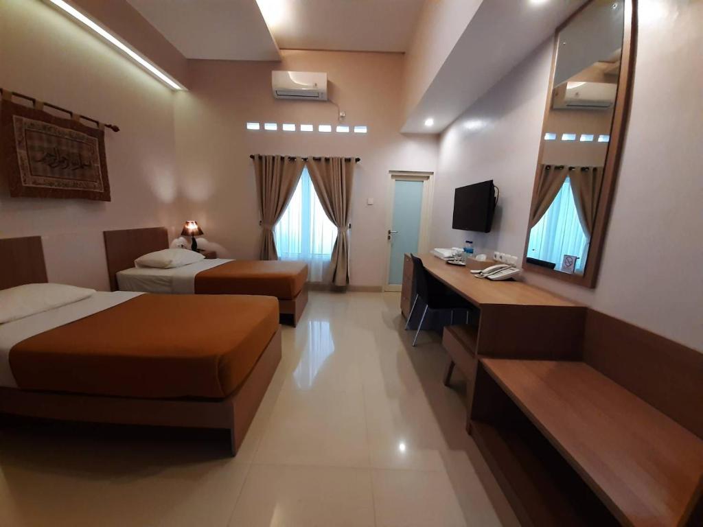 Postel nebo postele na pokoji v ubytování The Sriwijaya Hotel - Halal Hotel