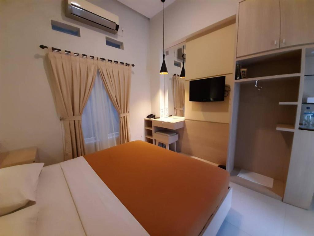 Postel nebo postele na pokoji v ubytování The Sriwijaya Hotel - Halal Hotel