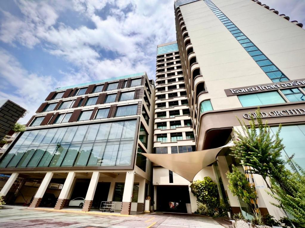 a building in a city with a building at Gold Orchid Bangkok Hotel in Bangkok