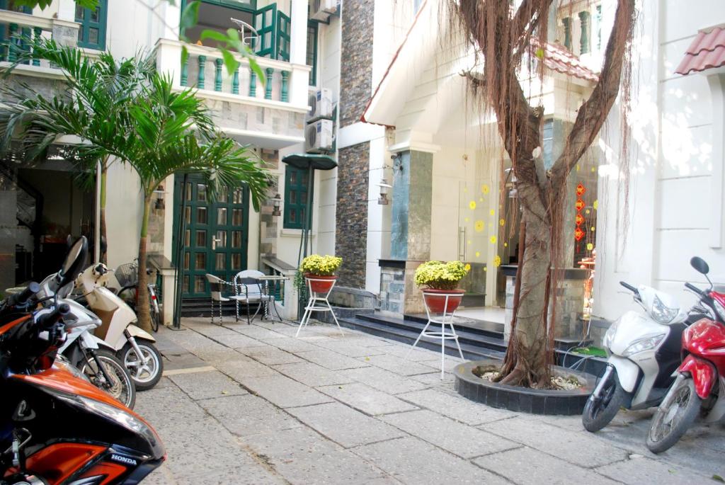 a group of motorcycles parked on a sidewalk next to a building at Lan Anh Hotel in Ho Chi Minh City