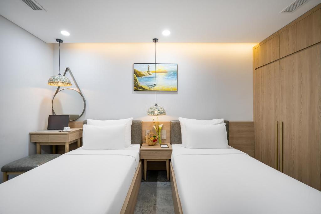 Postel nebo postele na pokoji v ubytování Nguyen Gia Hotel