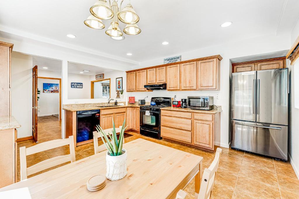 a kitchen with wooden cabinets and a table and a refrigerator at Summit House in Guerneville