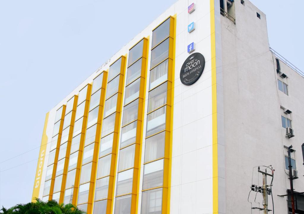 a building with a clock on the side of it at Bloom Hotel - Gachibowli in Hyderabad