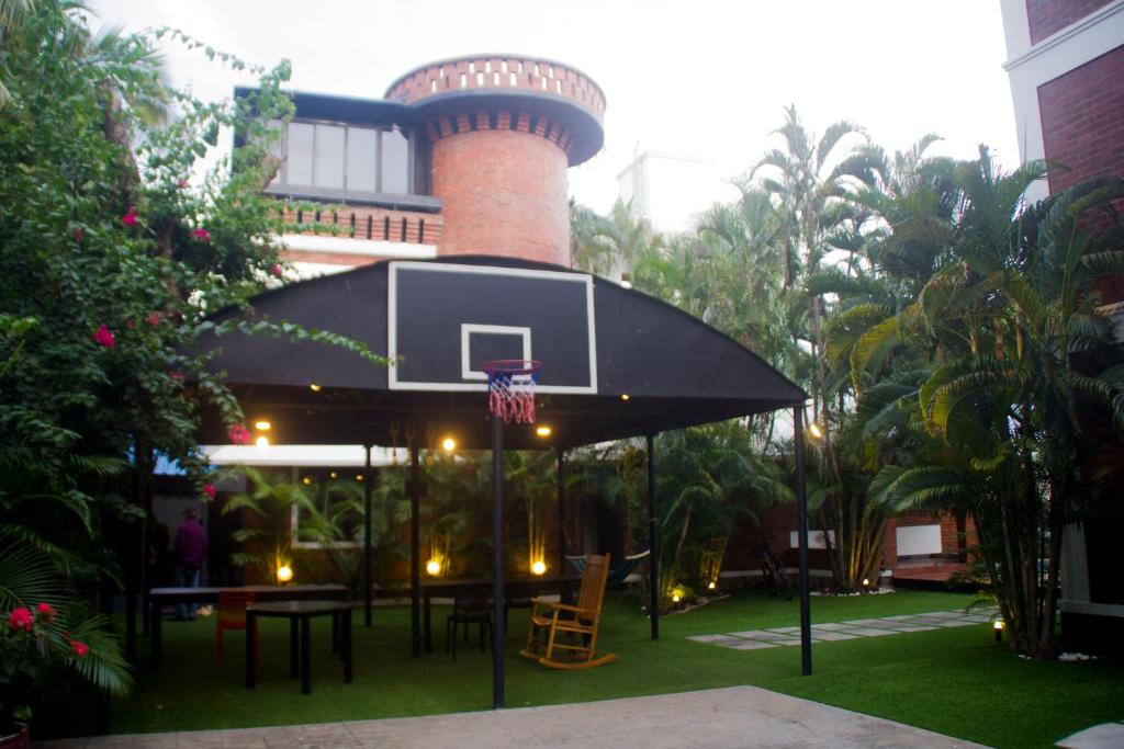 a building with a basketball hoop and a tower at BRICK CASTLE in Chennai