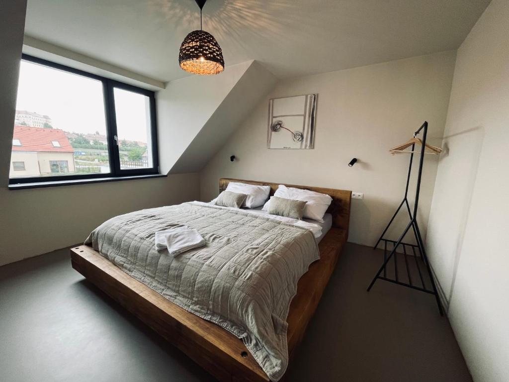 a bedroom with a large bed in a attic at Vilabyt se zahradou a výhledem na zámek in Mikulov