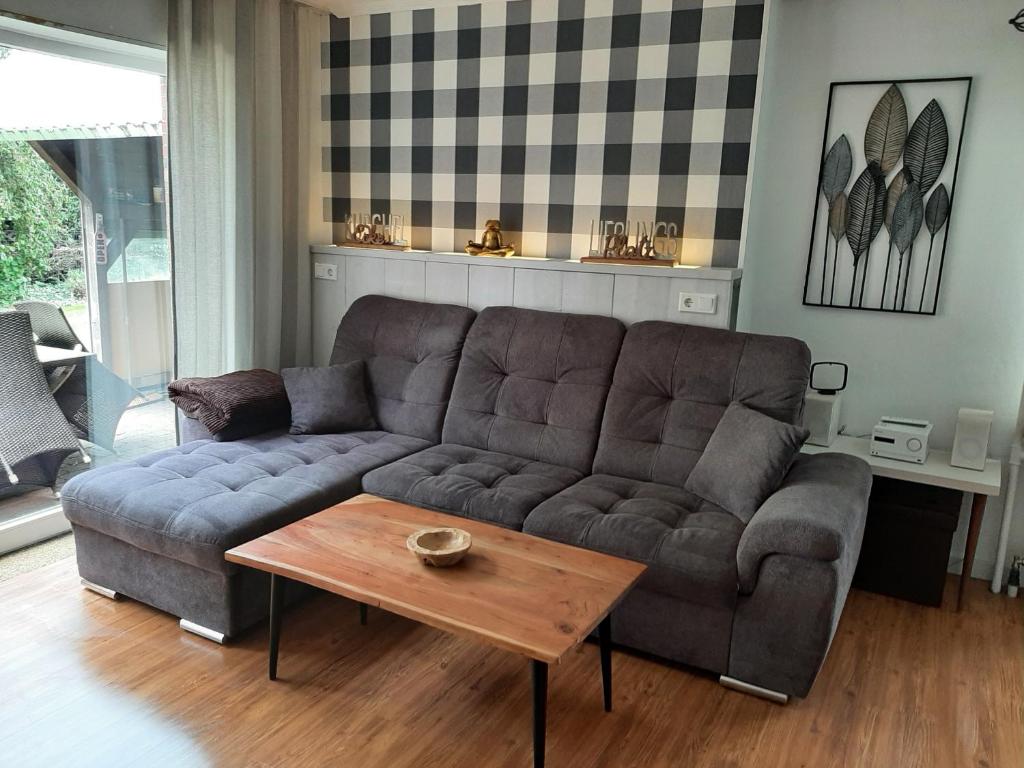 a living room with a couch and a coffee table at Ferienhaus Weitblick in Emden
