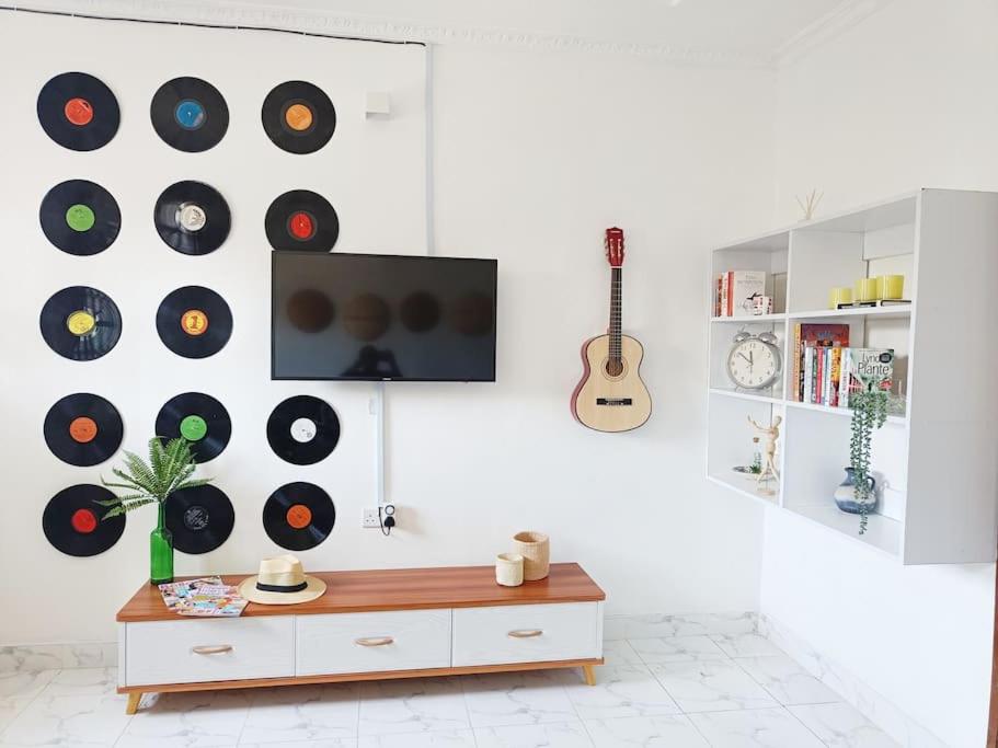 una sala de estar con un montón de discos en la pared en North Manor Nakuru en Nakuru